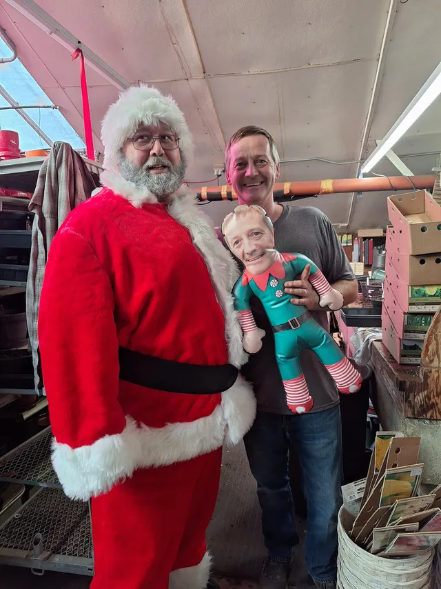 A custom elf cutout hidden in a downtown Rochester shop window for Elf Off The Shelf