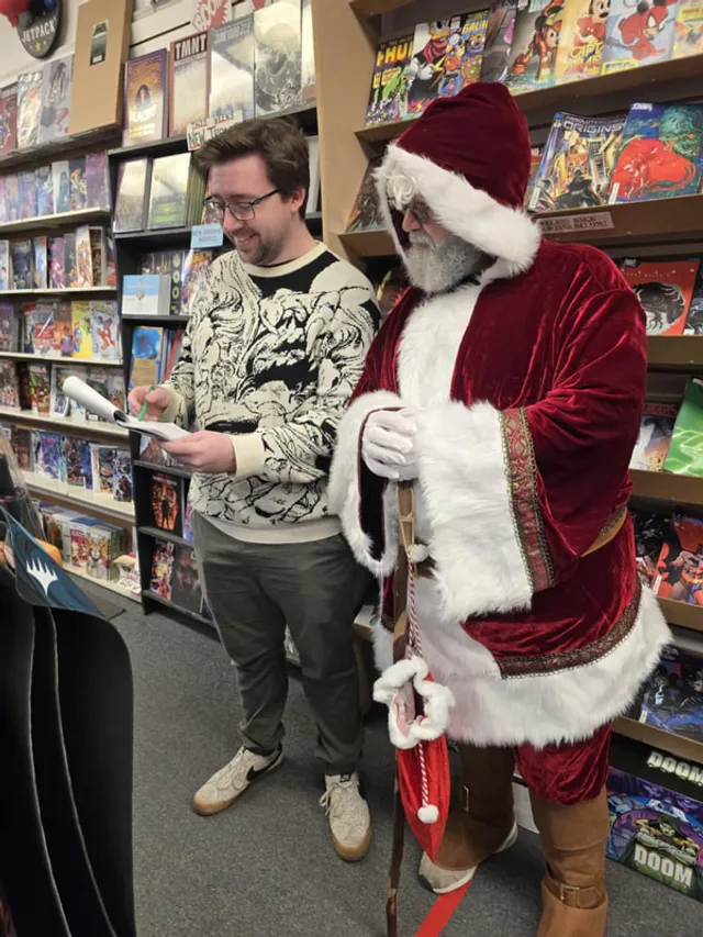Santa Claus greeting shoppers inside a downtown comic book store