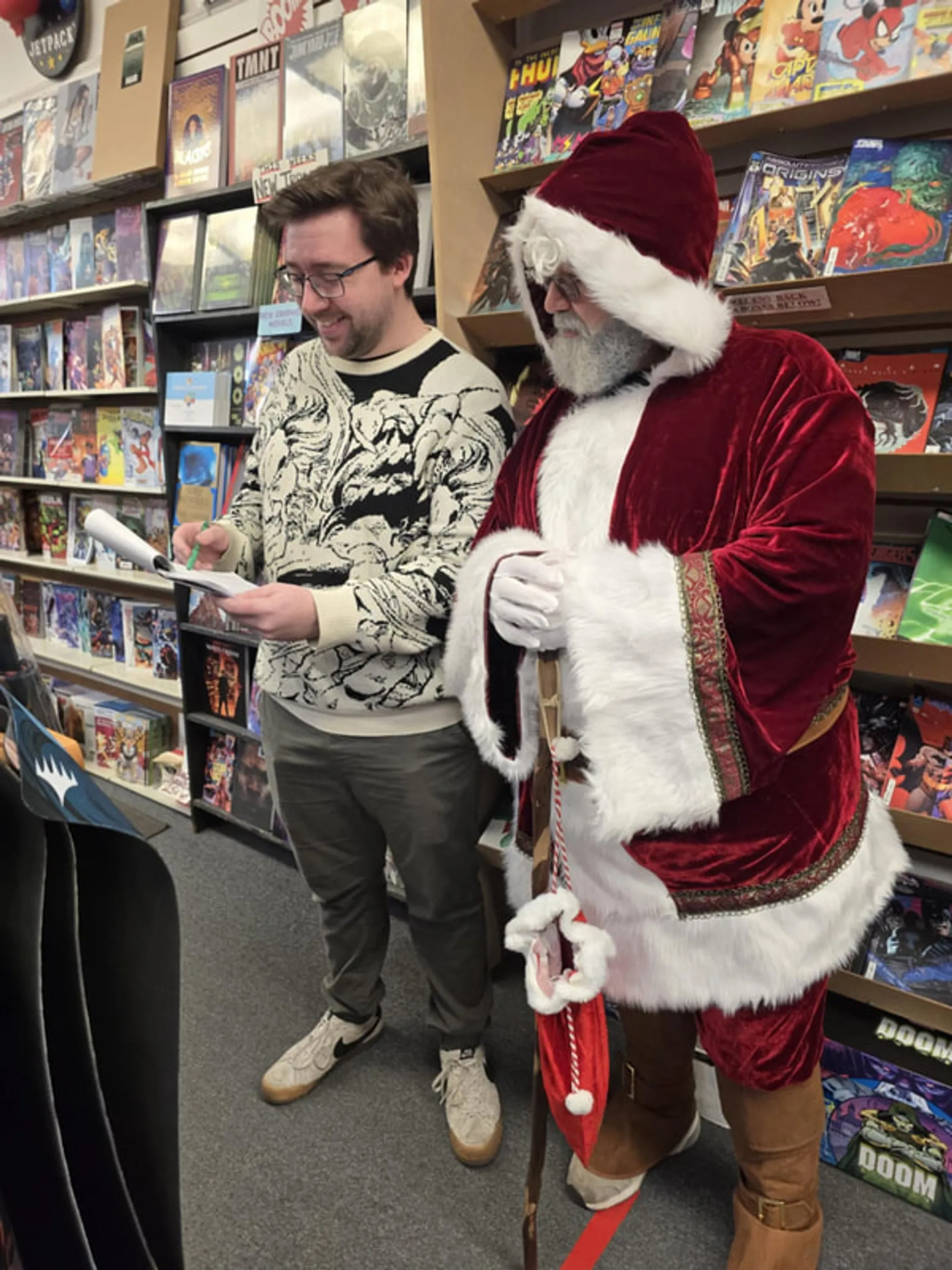 Santa Claus greeting shoppers inside a downtown comic book store
