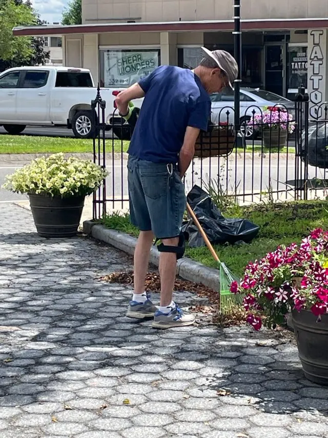 A volunteer tending the flower plantings in Central Square