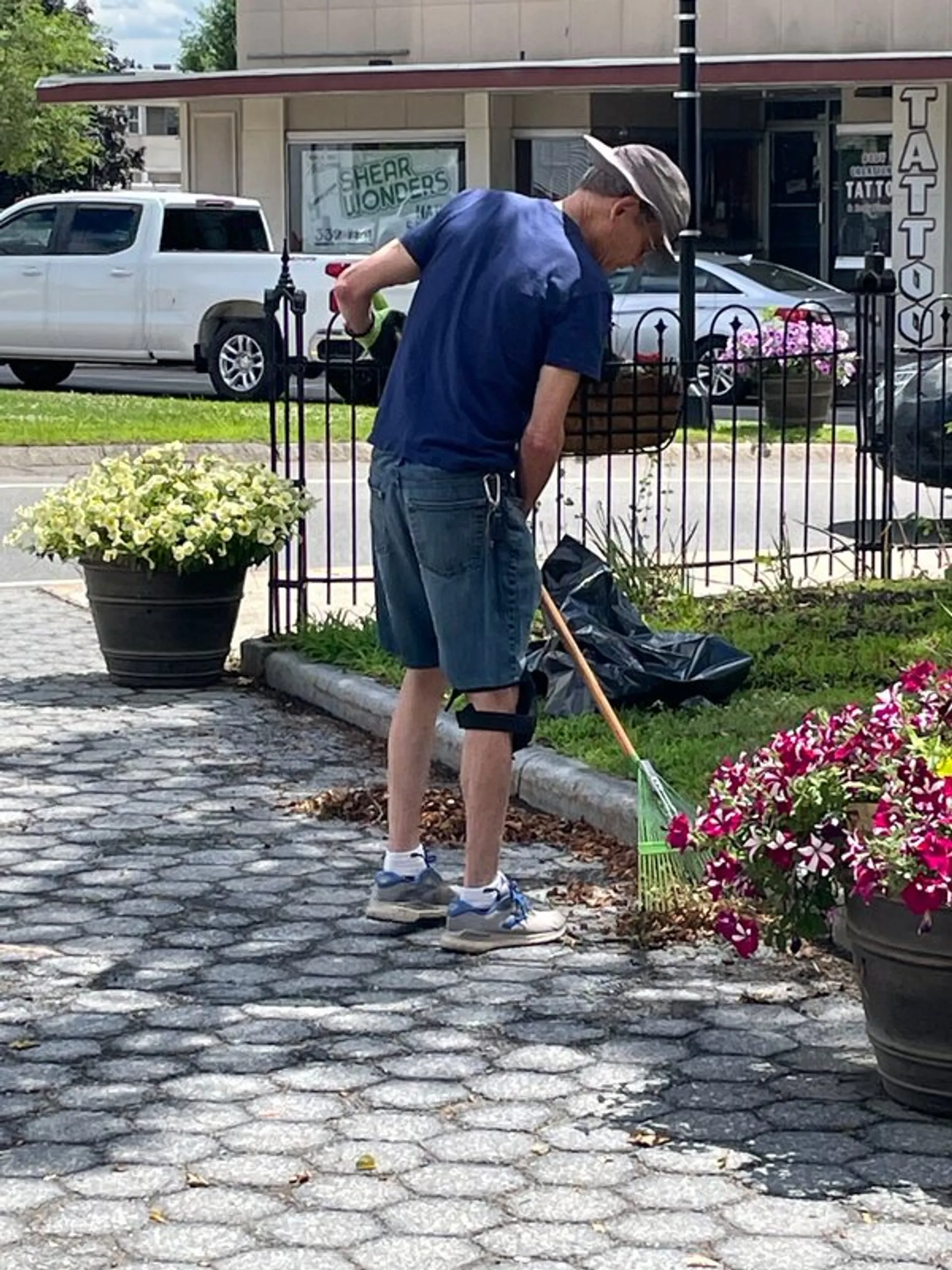 A volunteer tending the flower plantings in Central Square