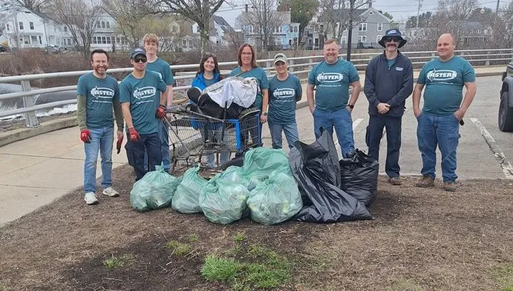 Rochester Cares volunteers with bags of collected litter after a community cleanup