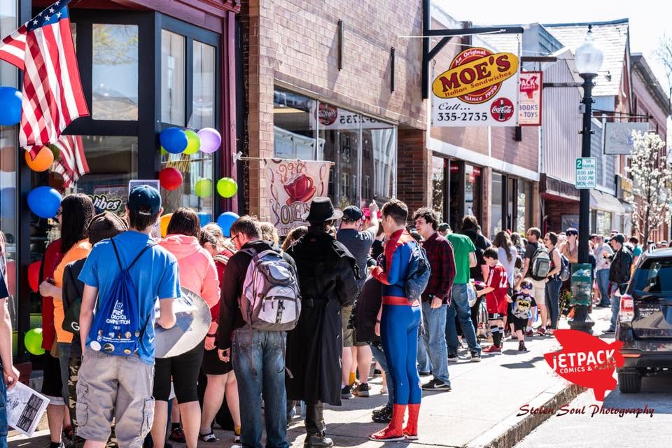 Crowds exploring downtown Rochester businesses during a community event